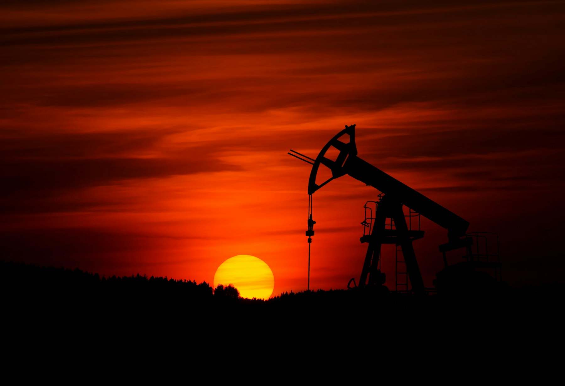 Oil pumpjack silhouetted against the sunset